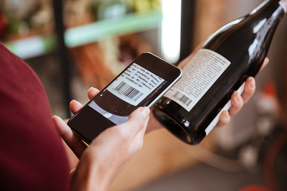 Person scanning a wine barcode with a mobile phone