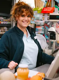 A woman cashier smiling