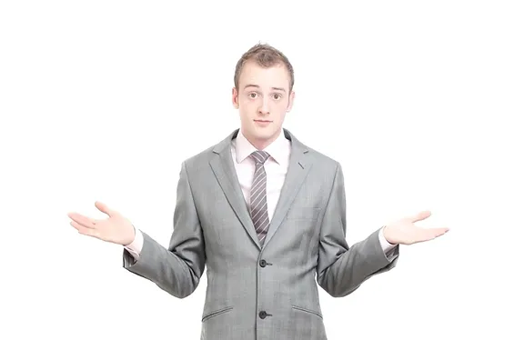 Man in suit gesturing his arms out