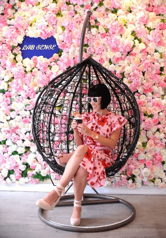 Cafe with a flower wall for people to take selfies in front of 